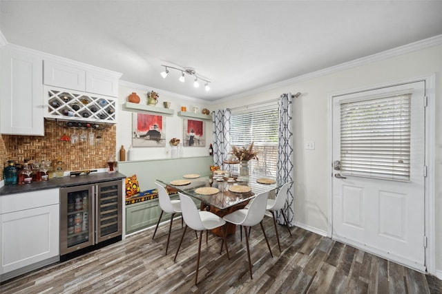 38 Wineberry Pl, The Woodlands, TX 77382 - dining area featuring beverage cooler, a dry bar, ornamental molding, dark wood-style flooring, and baseboards