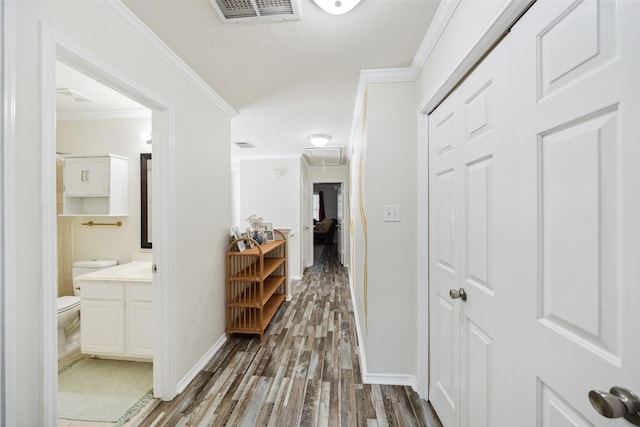 38 Wineberry Pl, The Woodlands, TX 77382 - hallway featuring wood finished floors, ornamental molding, baseboards, and attic access