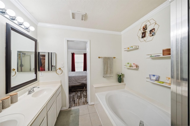 38 Wineberry Pl, The Woodlands, TX 77382 - bathroom featuring ornamental molding, tile patterned flooring, a garden tub, ensuite bath, and double vanity