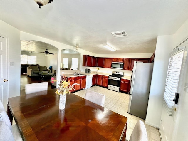 19334 Little Pine Ln, Katy, TX 77449 - dining room with light floors, arched walkways, a ceiling fan, and visible vents
