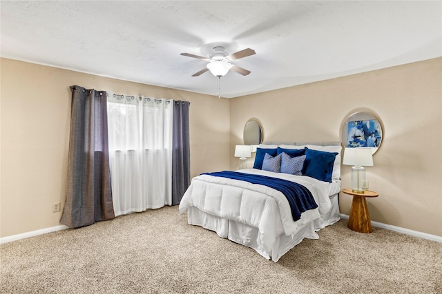 carpeted bedroom with ceiling fan and baseboards