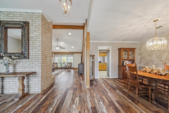 dining space featuring ornamental molding, ceiling fan with notable chandelier, visible vents, and dark wood-type flooring