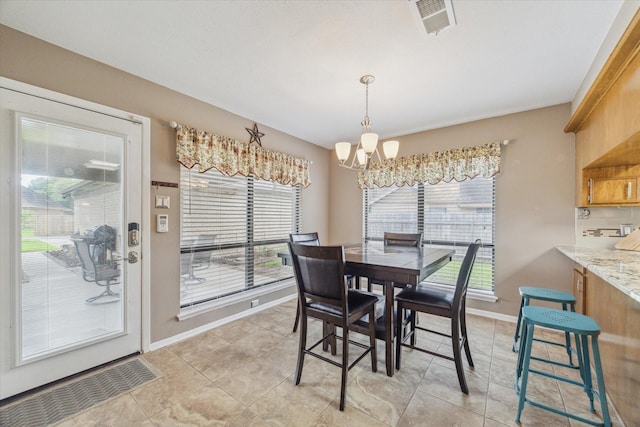 dining room with light tile patterned floors, baseboards, visible vents, and a chandelier
