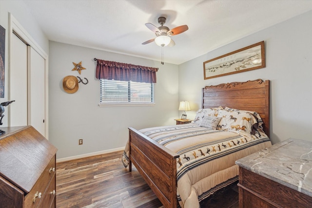 bedroom with baseboards, ceiling fan, a closet, and wood finished floors