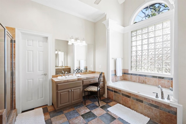 4304 Newcastle Ct, Bryan, TX 77802 - bathroom featuring a garden tub, vanity, a shower stall, and decorative columns
