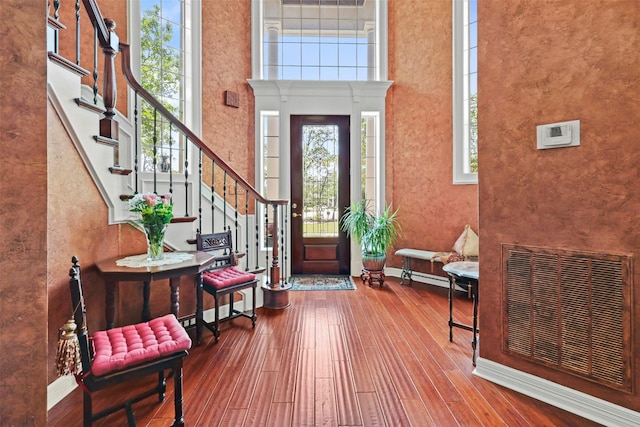 4304 Newcastle Ct, Bryan, TX 77802 - foyer with stairway, hardwood / wood-style flooring, a high ceiling, and baseboards
