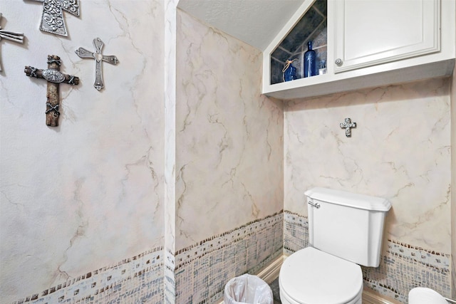 4304 Newcastle Ct, Bryan, TX 77802 - half bathroom with toilet and tile walls