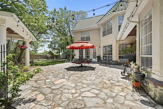 4304 Newcastle Ct, Bryan, TX 77802 - fenced backyard with a patio area, a playground, and outdoor dining area