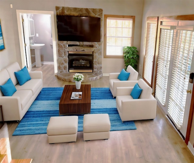 11 Ridgeway St, Coldspring, TX 77331 - living area with a stone fireplace, baseboards, and wood finished floors