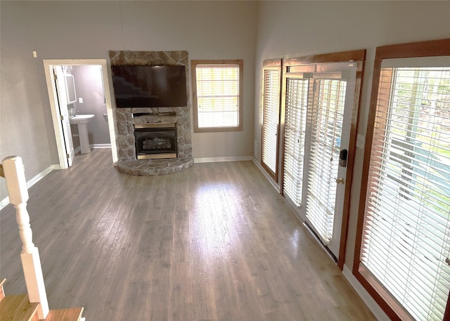 11 Ridgeway St, Coldspring, TX 77331 - unfurnished living room with baseboards, a stone fireplace, and wood finished floors
