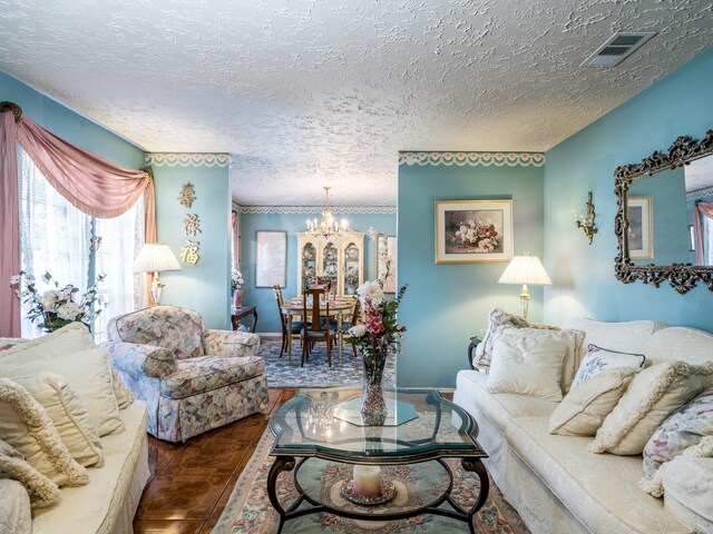 1814 Cliffdale Dr, Missouri City, TX 77489 - living area with visible vents, an inviting chandelier, and a textured ceiling