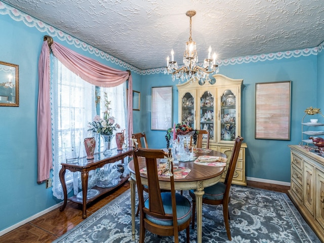 1814 Cliffdale Dr, Missouri City, TX 77489 - dining space with baseboards, a textured ceiling, and a chandelier