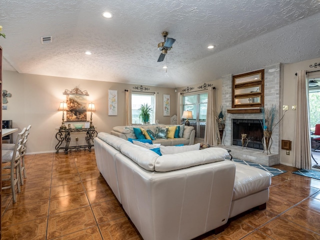 1814 Cliffdale Dr, Missouri City, TX 77489 - living room with a brick fireplace, tile patterned flooring, a textured ceiling, and visible vents