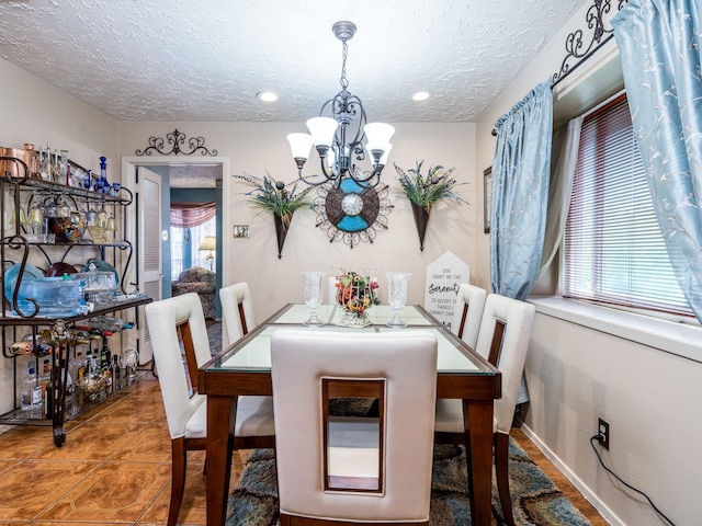 1814 Cliffdale Dr, Missouri City, TX 77489 - dining area with tile patterned floors, a textured ceiling, a notable chandelier, and a healthy amount of sunlight