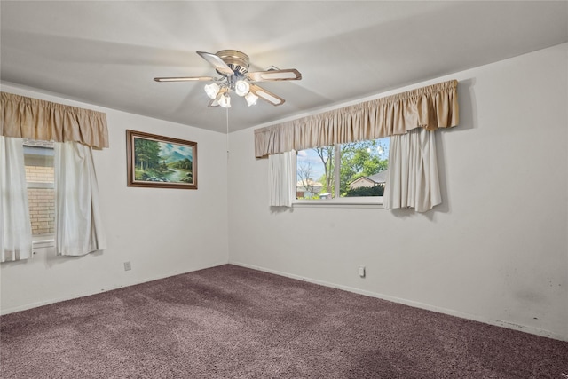 empty room with dark carpet and ceiling fan