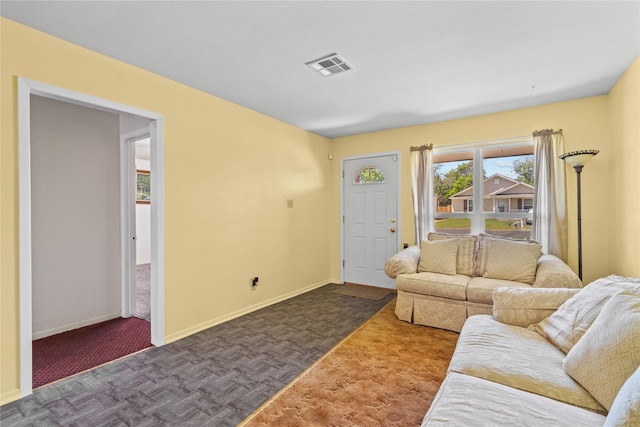 living room with visible vents and baseboards