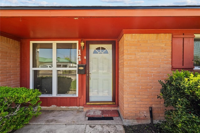 entrance to property with brick siding