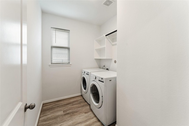 546 Long Beach Bay Dr, Katy, TX 77493 - laundry area with light wood-style floors, visible vents, washing machine and dryer, baseboards, and laundry area