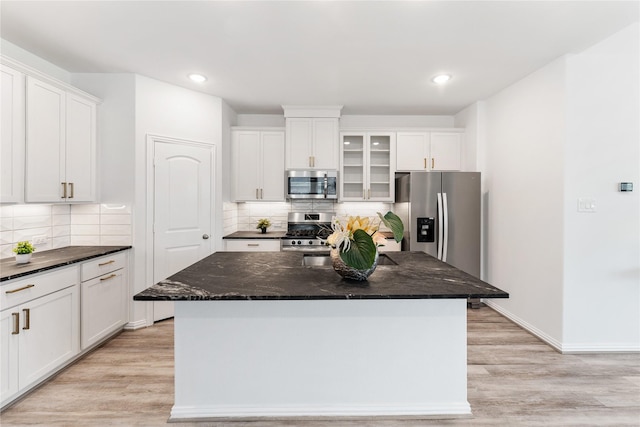 546 Long Beach Bay Dr, Katy, TX 77493 - kitchen featuring white cabinets, appliances with stainless steel finishes, and light wood-type flooring