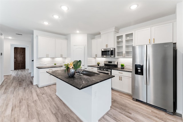 546 Long Beach Bay Dr, Katy, TX 77493 - kitchen featuring white cabinets, stainless steel appliances, a sink, light wood-type flooring, and decorative backsplash