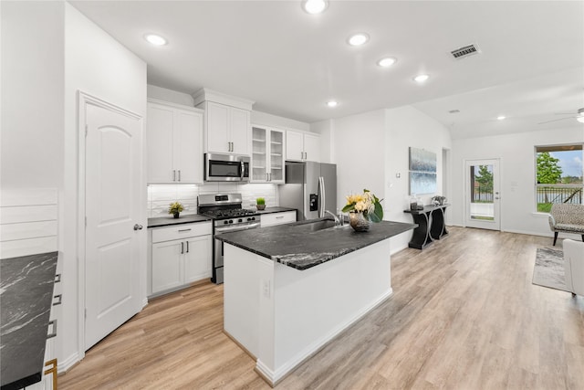 546 Long Beach Bay Dr, Katy, TX 77493 - kitchen with dark countertops, tasteful backsplash, a sink, light wood-style floors, and appliances with stainless steel finishes