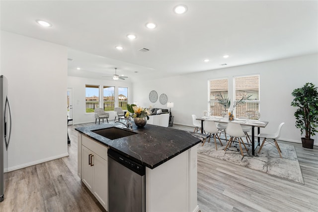 546 Long Beach Bay Dr, Katy, TX 77493 - kitchen with dark stone counters, a sink, light wood-style flooring, appliances with stainless steel finishes, and recessed lighting