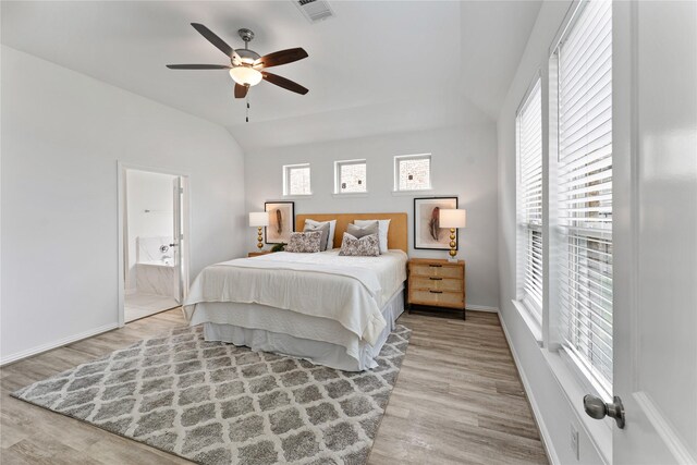 546 Long Beach Bay Dr, Katy, TX 77493 - bedroom with vaulted ceiling, wood finished floors, connected bathroom, baseboards, and visible vents
