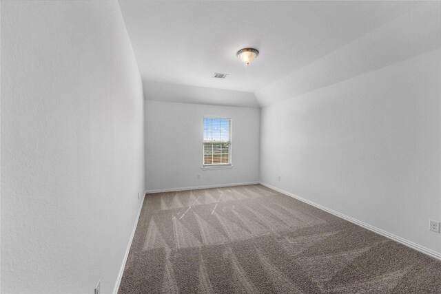 546 Long Beach Bay Dr, Katy, TX 77493 - empty room with vaulted ceiling, visible vents, carpet flooring, and baseboards