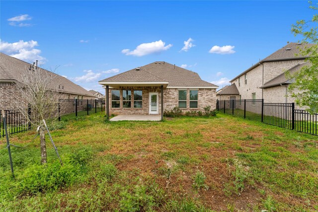 546 Long Beach Bay Dr, Katy, TX 77493 - rear view of property featuring a fenced backyard, a yard, roof with shingles, a patio, and brick siding