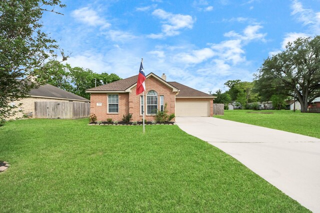 3011 Fairchild Ave, Needville, TX 77461 - view of front of property featuring driveway, fence, brick siding, an attached garage, and a front yard