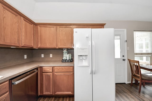 3011 Fairchild Ave, Needville, TX 77461 - kitchen featuring stainless steel dishwasher, dark wood-style floors, white refrigerator with ice dispenser, brown cabinetry, and light countertops