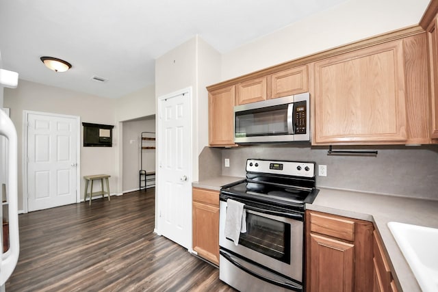 3011 Fairchild Ave, Needville, TX 77461 - kitchen with a sink, visible vents, light countertops, dark wood-type flooring, and appliances with stainless steel finishes