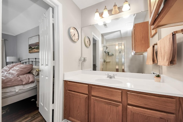 3011 Fairchild Ave, Needville, TX 77461 - ensuite bathroom featuring ensuite bath, vanity, wood finished floors, and a stall shower