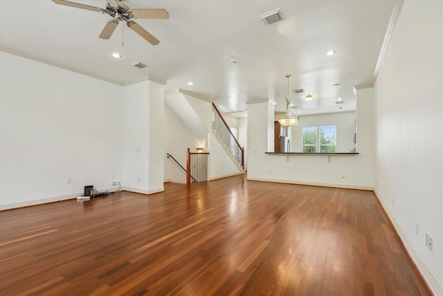 91 Sidney St, Houston, TX 77003 - unfurnished living room with wood finished floors, visible vents, crown molding, and a ceiling fan