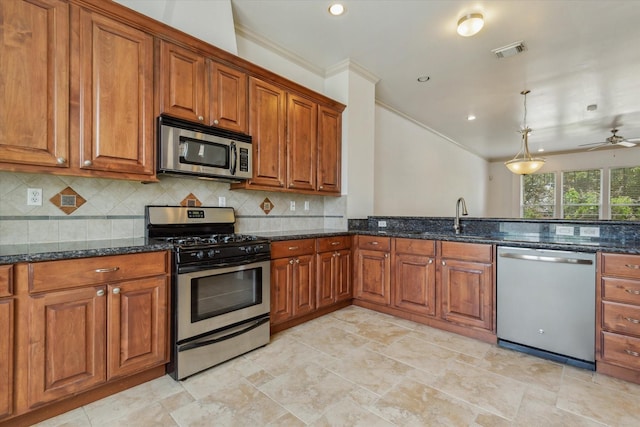 91 Sidney St, Houston, TX 77003 - kitchen with visible vents, a sink, crown molding, brown cabinetry, and appliances with stainless steel finishes