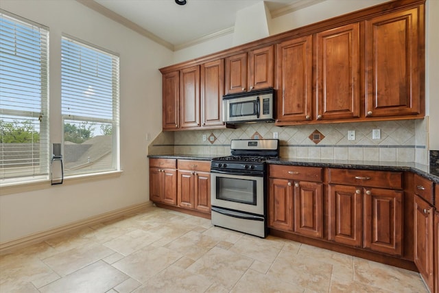 91 Sidney St, Houston, TX 77003 - kitchen featuring backsplash, brown cabinets, crown molding, and stainless steel appliances