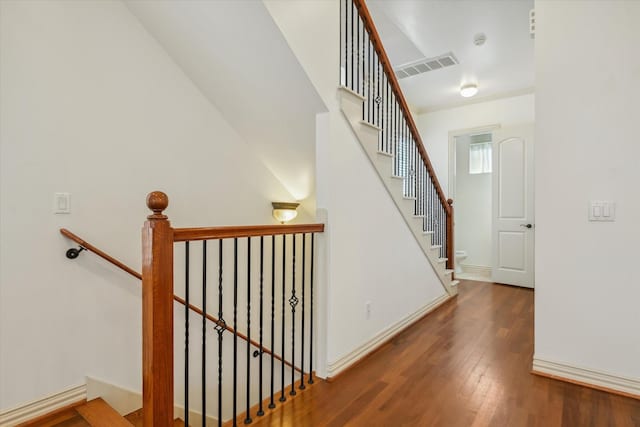 91 Sidney St, Houston, TX 77003 - stairs featuring wood finished floors, visible vents, and baseboards