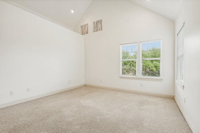 91 Sidney St, Houston, TX 77003 - empty room with light colored carpet, baseboards, recessed lighting, and high vaulted ceiling