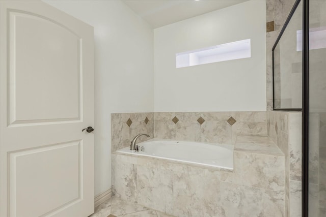 91 Sidney St, Houston, TX 77003 - full bathroom with a bath, a shower stall, and a skylight