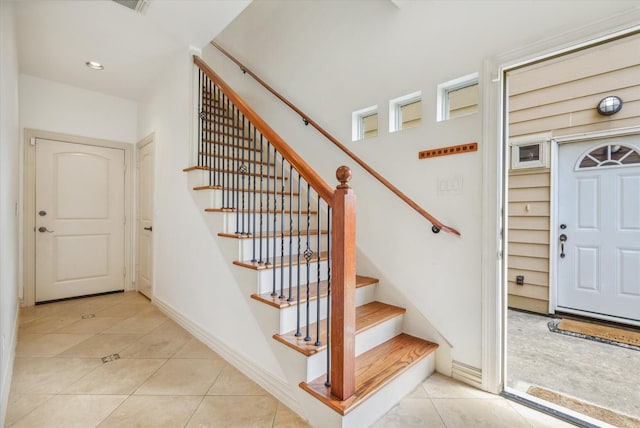 91 Sidney St, Houston, TX 77003 - stairs with baseboards, tile patterned flooring, and visible vents