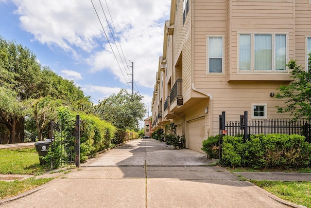 91 Sidney St, Houston, TX 77003 - view of home's exterior with fence, driveway, and a garage