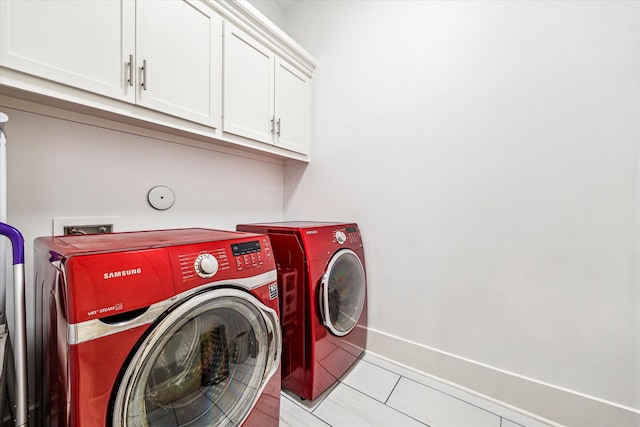 4958 Edison Park Ln, Houston, TX 77081 - clothes washing area with light tile patterned flooring, baseboards, cabinet space, and washing machine and dryer