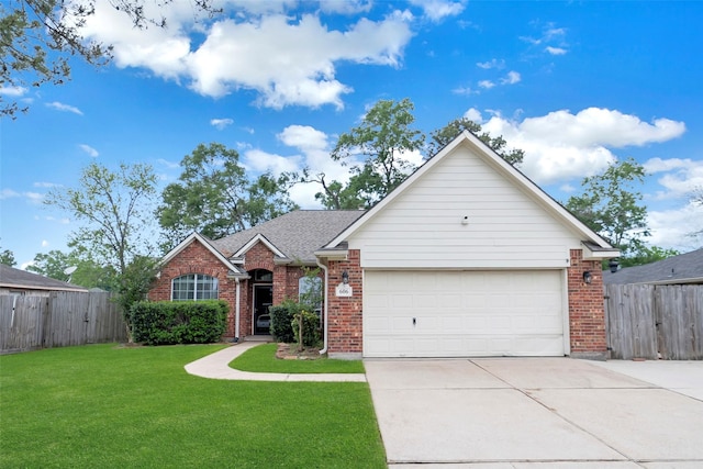 606 Sea Anchor Way, Crosby, TX 77532 - view of front of home with fence, a front lawn, concrete driveway, and brick siding