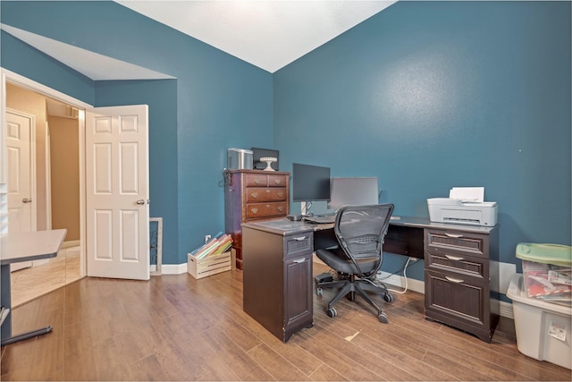 606 Sea Anchor Way, Crosby, TX 77532 - office space featuring lofted ceiling, wood finished floors, and baseboards