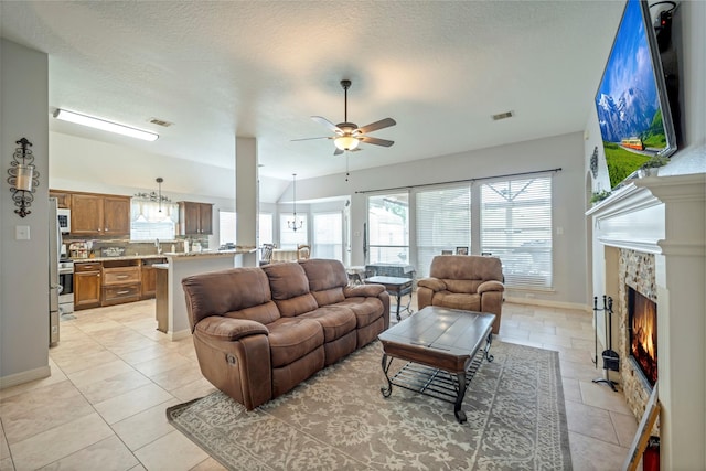 606 Sea Anchor Way, Crosby, TX 77532 - living room featuring baseboards, a ceiling fan, visible vents, and a lit fireplace