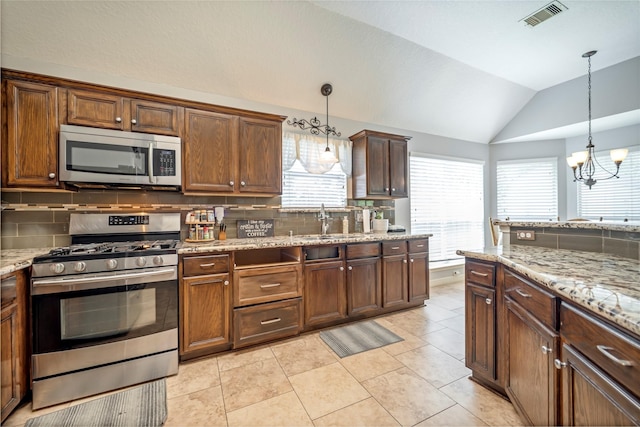 606 Sea Anchor Way, Crosby, TX 77532 - kitchen featuring a sink, a healthy amount of sunlight, lofted ceiling, appliances with stainless steel finishes, and visible vents