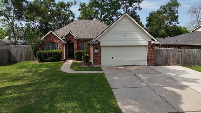606 Sea Anchor Way, Crosby, TX 77532 - view of front facade with fence, brick siding, and an attached garage