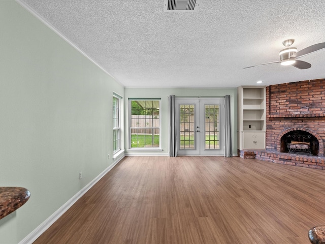 unfurnished living room featuring a ceiling fan, a textured ceiling, and visible vents