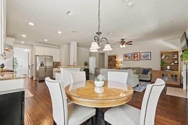13115 Parkbrook Way Ln, Sugar Land, TX 77498 - dining area with recessed lighting, dark wood-style floors, a chandelier, and a ceiling fan