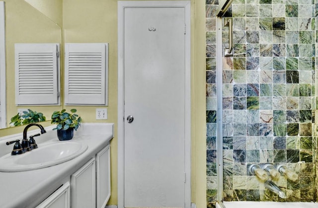 full bathroom with a shower stall and vanity